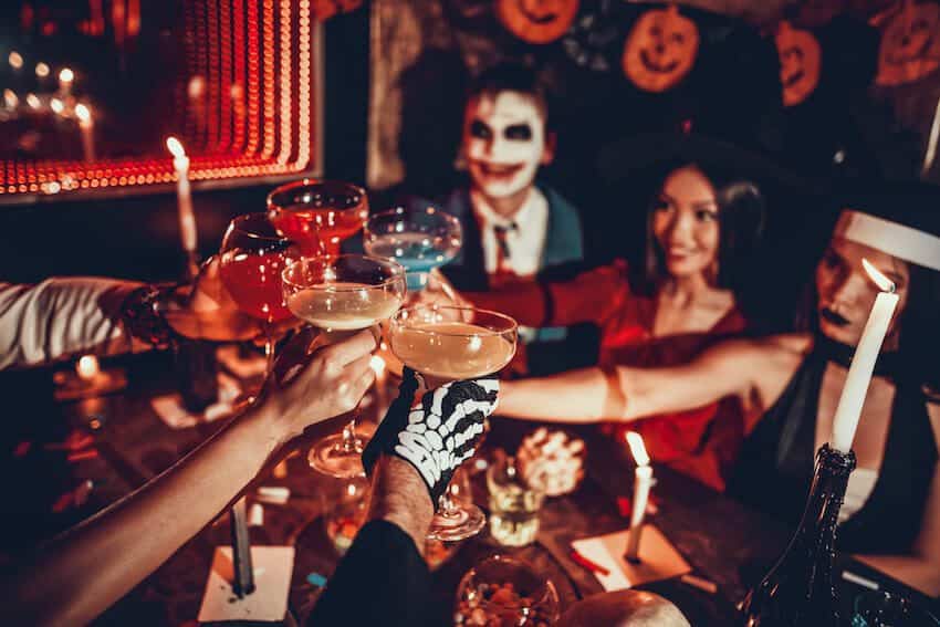 people having a toast at a Halloween costume party UDdW wUGliL